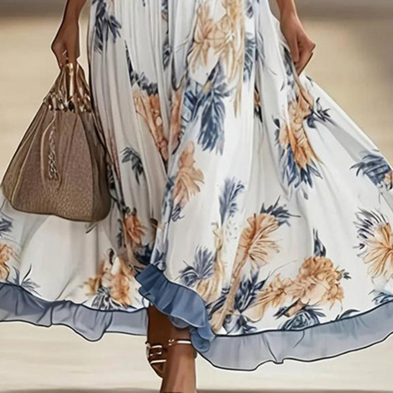 Women's floral print maxi dress with deep V-neck and flare sleeves, casualwear by Plush Fashion Hub, shown on a model.