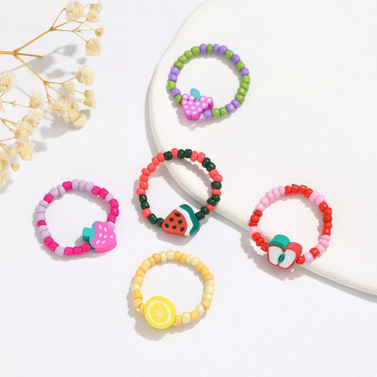 Colorful fruit charm beaded ring by Shopimist featuring vibrant fruit-shaped beads and a stylish band.