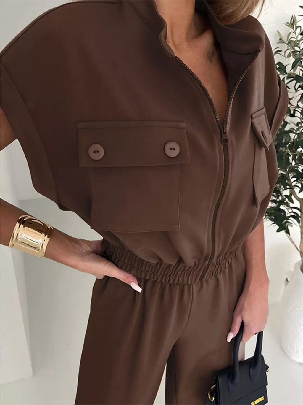 Black cargo pocket zipper front jumpsuit by Shopimist, featuring functional pockets and a front zipper closure.