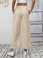 Women's striped wide-leg drawstring pants with pockets by Trendsi, featuring a relaxed fit and stylish design.