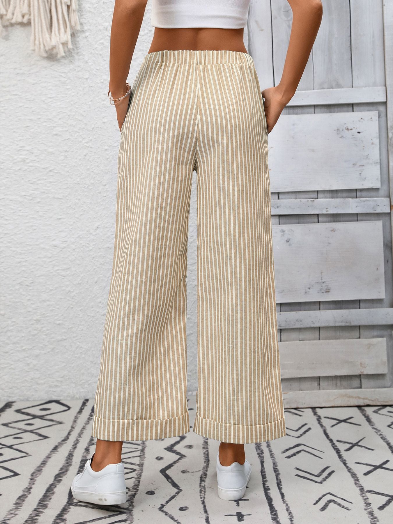 Women's striped wide-leg drawstring pants with pockets by Trendsi, featuring a relaxed fit and stylish design.