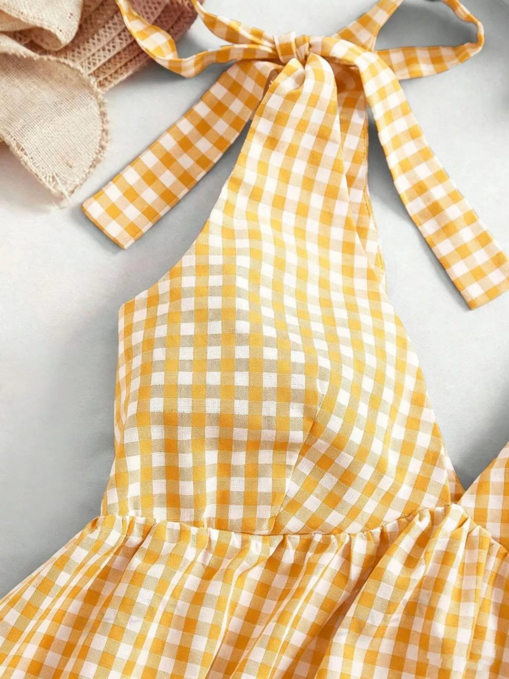 Gingham tie-shoulder mini dress by Plush Fashion Hub featuring a stylish skirt with a fitted silhouette and shoulder tie details.