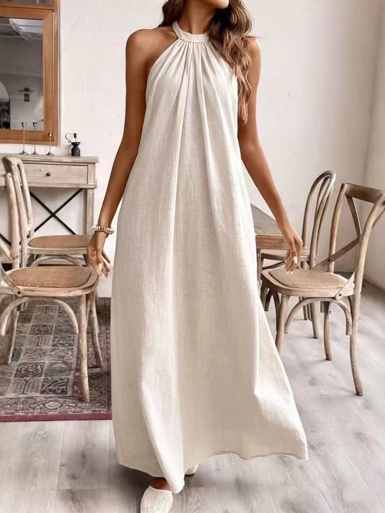 Plush Fashion Hub halter neck maxi dress with flowing fabric and sleeveless design, perfect for elegant summer occasions.