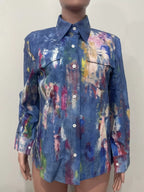 Artistic painted long sleeve denim shirt by Plush Fashion Hub featuring colorful, creative designs on a classic blue denim fabric.