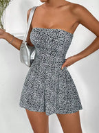 Black strapless romper with ruched waist and fitted design, perfect for stylish summer looks by Trendsi.