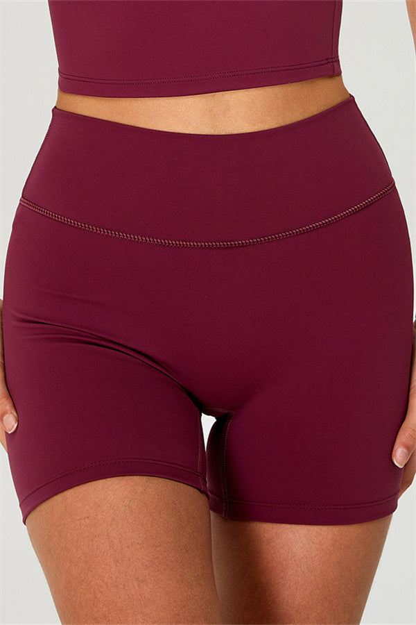 Fitglutes activewear: One-shoulder crop top and matching shorts 2-piece gym set, stylish sportswear for workout and active lifestyle.