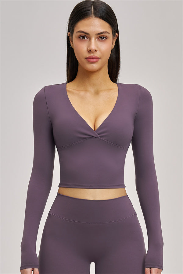 Black long sleeve crop top from Fitglutes Activewear, featuring a fitted design and breathable fabric for workout and casual wear.