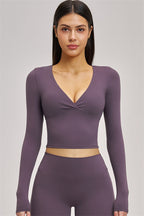 Black long sleeve crop top from Fitglutes Activewear, featuring a fitted design and breathable fabric for workout and casual wear.