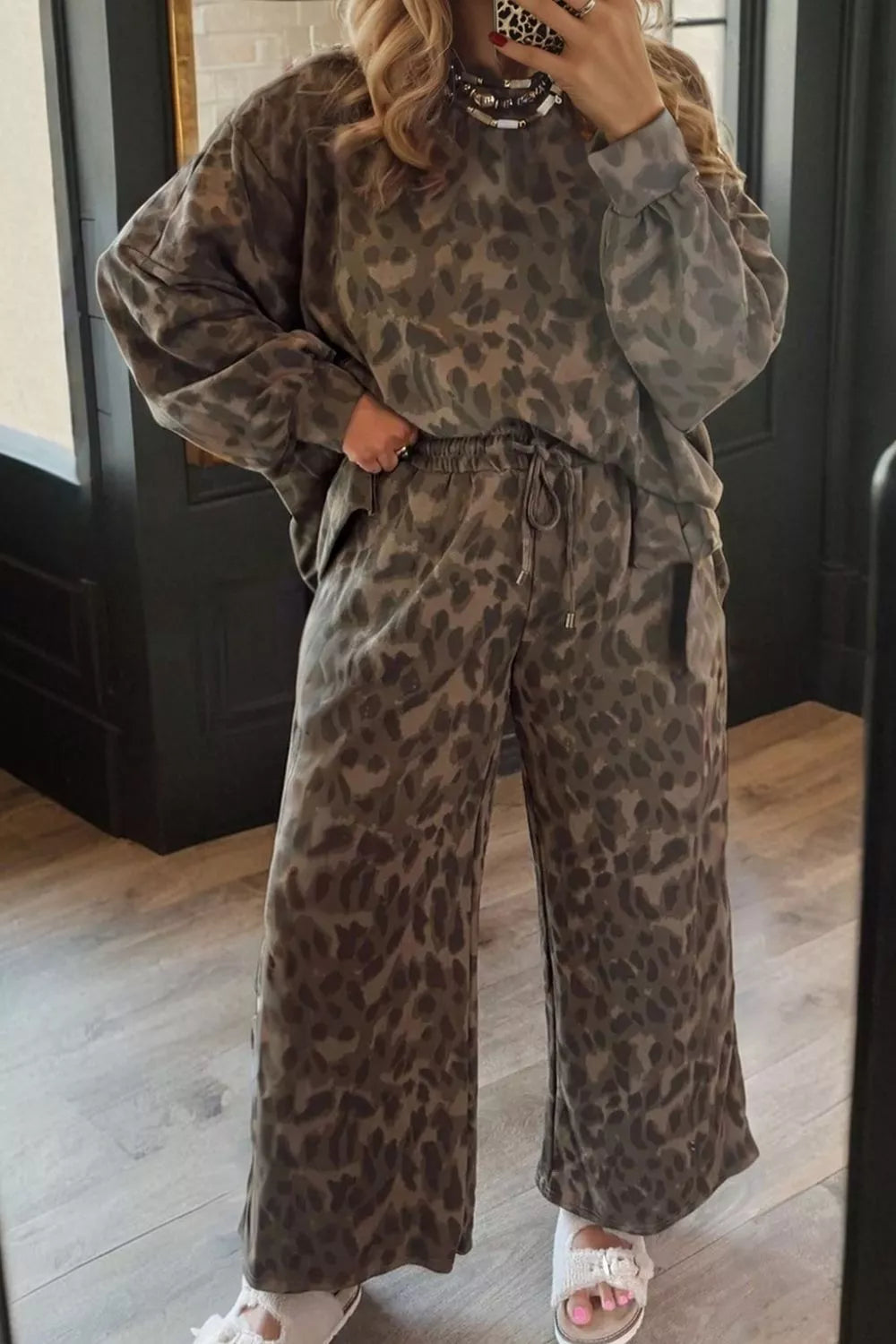 Leopard print long sleeve top and pants matching set by Trendsi, featuring a stylish animal pattern and comfortable fit.