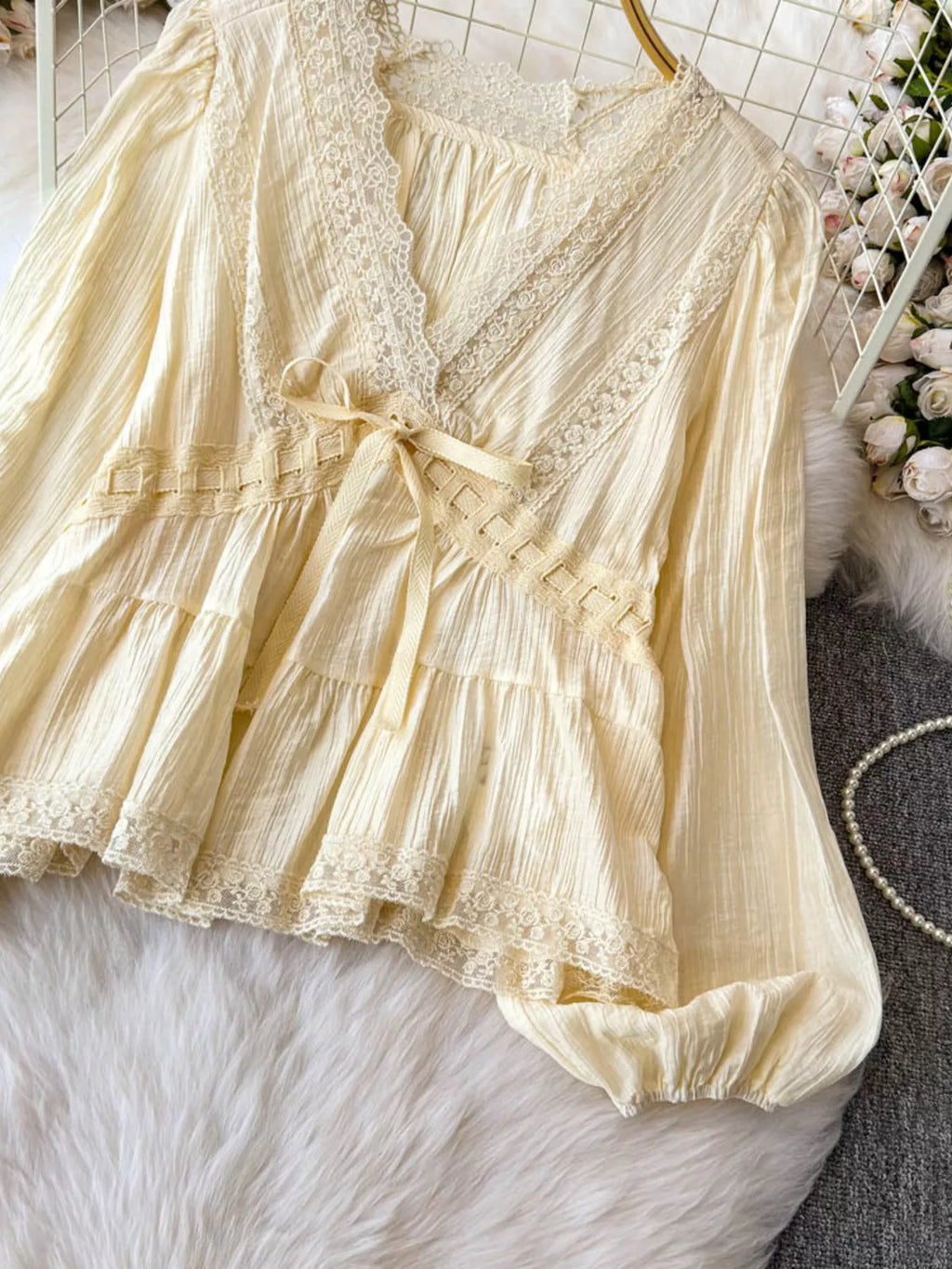Lace detail V-neck blouse dress from Trendsi featuring a fitted silhouette and elegant design, shown on a model.
