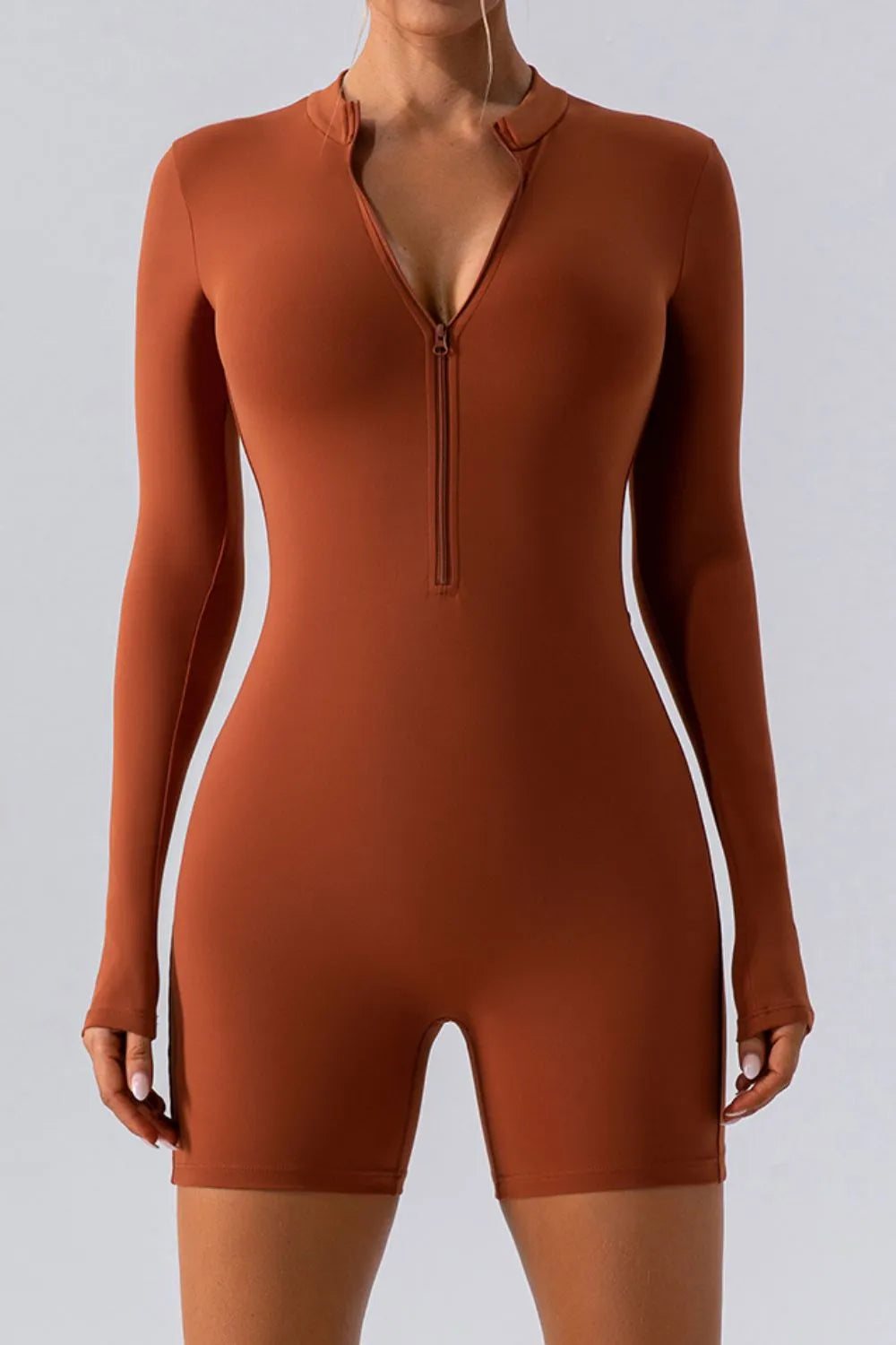 Trendsi half zip long sleeve active romper in black, featuring a fitted design and stretchy fabric for active wear.