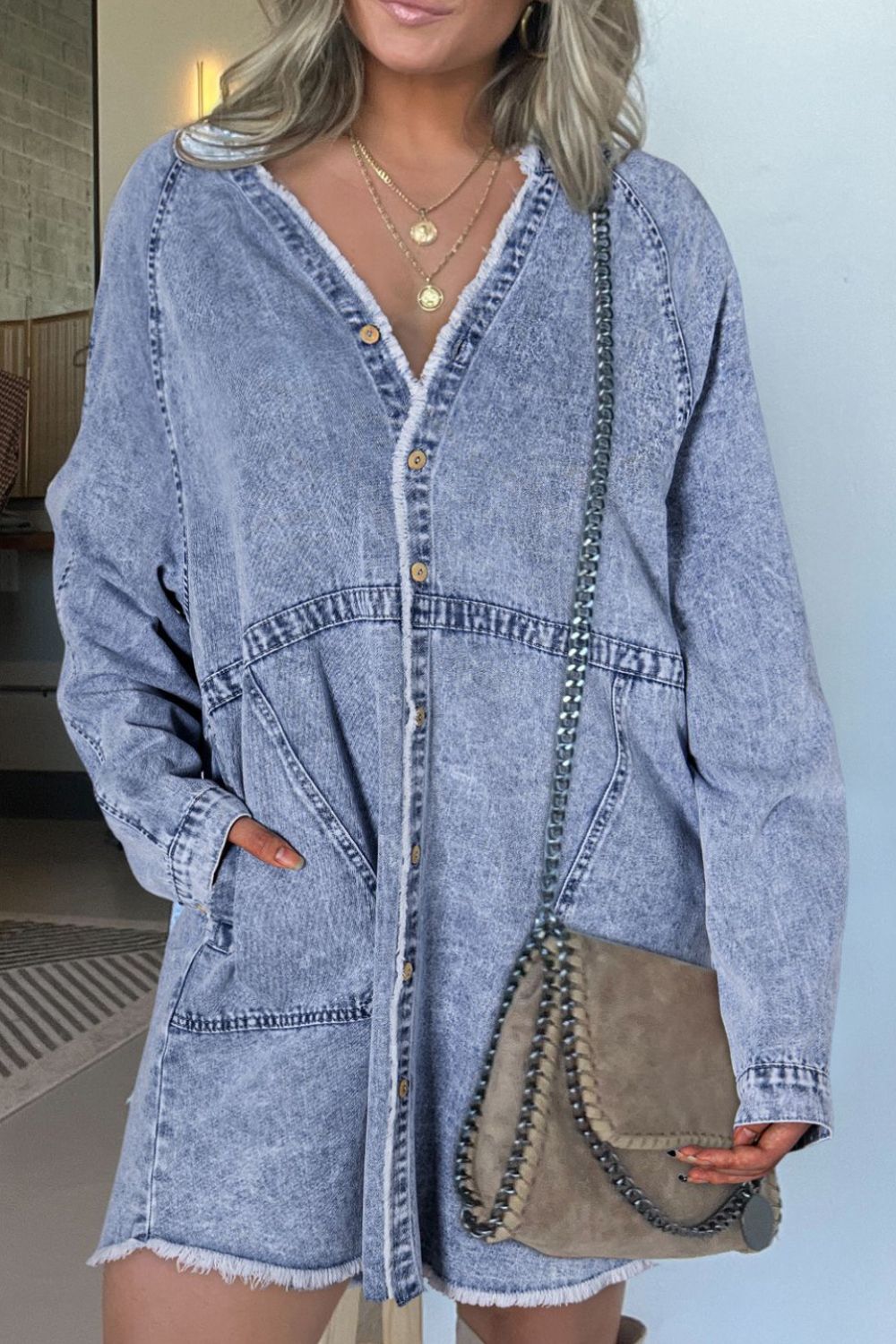 Long sleeve denim dress with button-down front and raw hem, stylish clothing from Plush Fashion Hub.