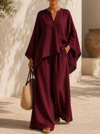Plus size loungewear set featuring a notched long sleeve top and wide-leg pants in soft, comfortable fabric.