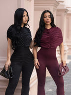 Ruched flare leg jumpsuit by Trendsi featuring a fitted bodice, flared pants, and stylish design in a solid color.