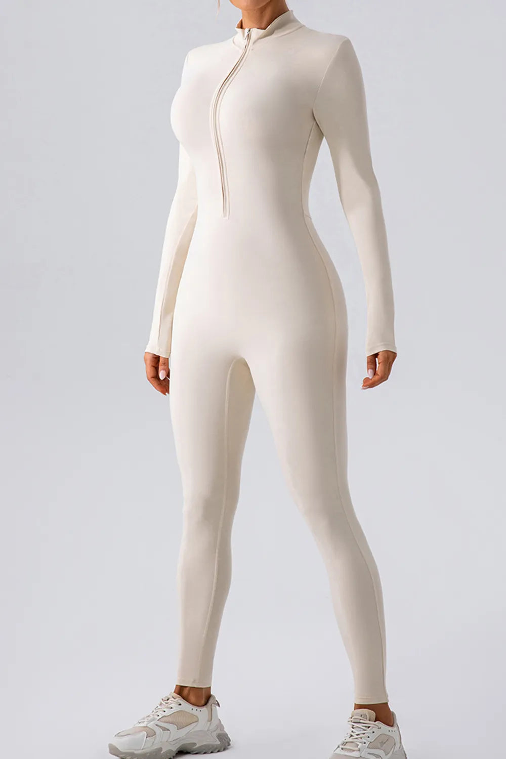 Black half zip mock neck active jumpsuit by Trendsi, featuring a fitted design and breathable fabric for comfortable active wear.