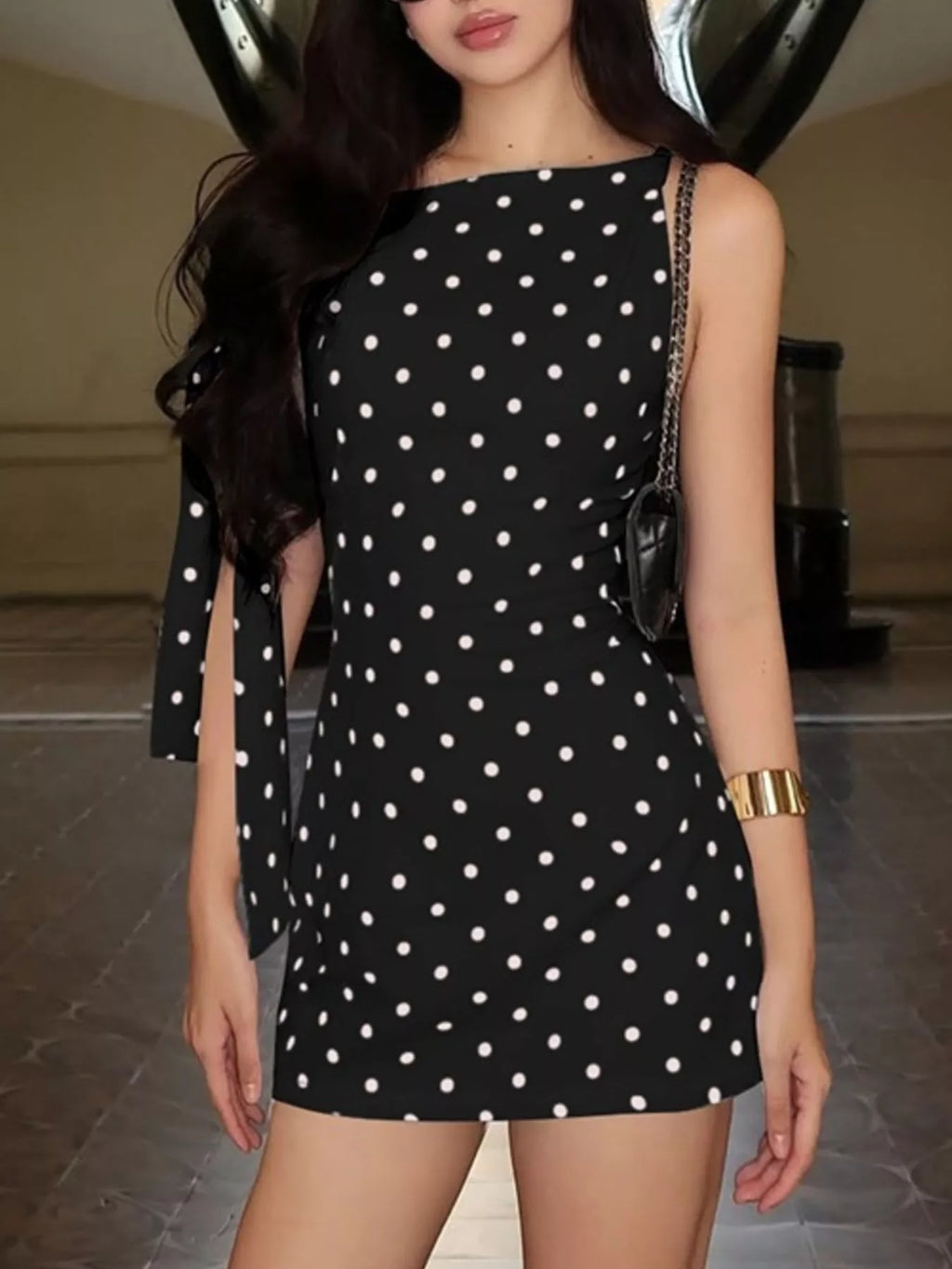 Polka dot sleeveless mini dress with bow accents by Shopimist, showcasing a stylish dress with a playful pattern and feminine details.