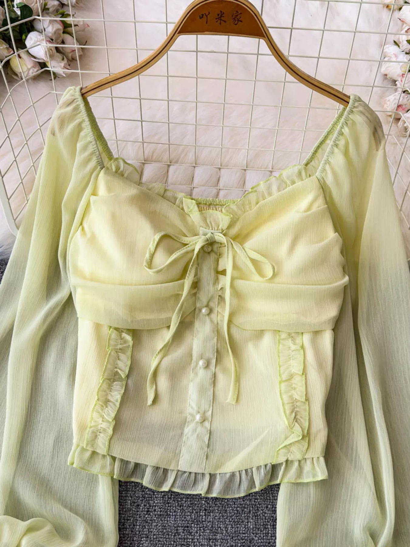 Women's elegant frill flounce sleeve smocked blouse made of lightweight polyester, featuring ruffled details and a stylish dress design.
