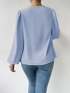 Loose draped Bella Mia long-sleeved V-neck shirt for women, showcasing a relaxed fit and stylish design.