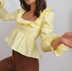 Summer Wind Women solid color long sleeve ruffled shirt by Bella Mia, featuring lightweight fabric and feminine ruffle details.