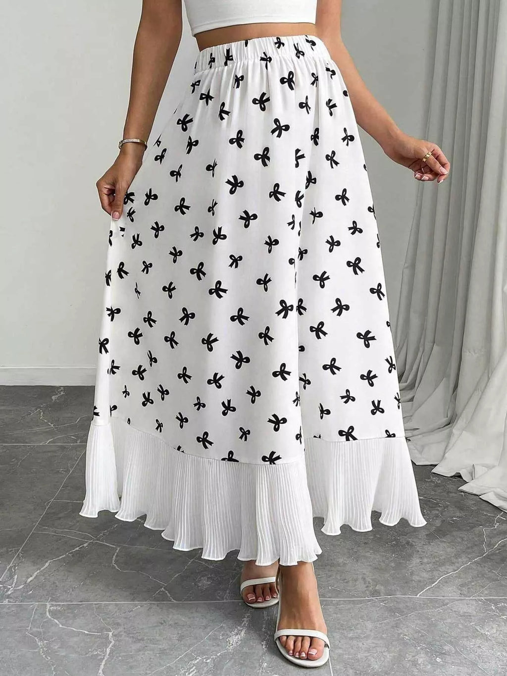 Flowy maxi skirt with bow print and ruffle hem from Trendsi, featuring a lightweight, feminine design and vibrant pattern.