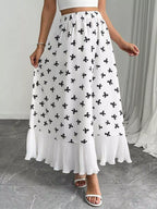 Flowy maxi skirt with bow print and ruffle hem from Trendsi, featuring a lightweight, feminine design and vibrant pattern.