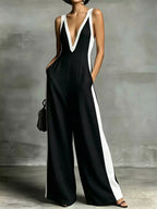 Deep V-neck wide-leg jumpsuit with contrast trim from Shopimist, featuring a stylish neckline and relaxed fit.