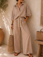 Plus size striped puff sleeve shirt and wide-leg drawstring pants set by Trendsi, featuring a stylish, comfortable matching outfit.