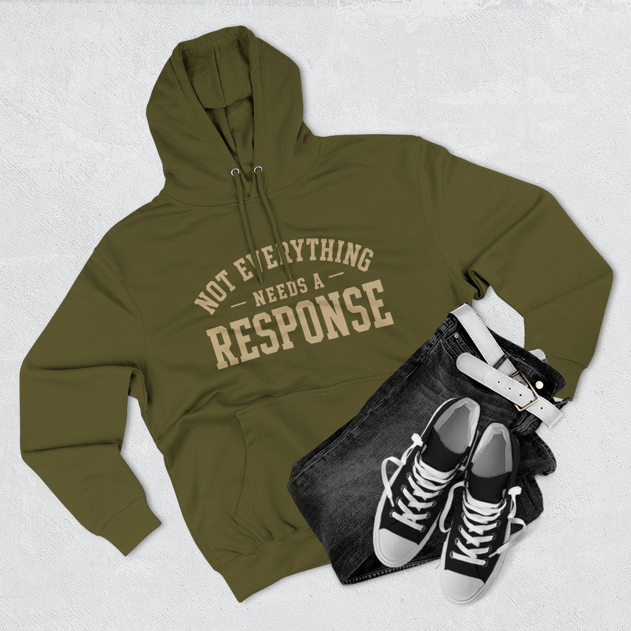 Black hoodie from Wear Your Worship's Not Everything Needs a Response collection with printed text design.