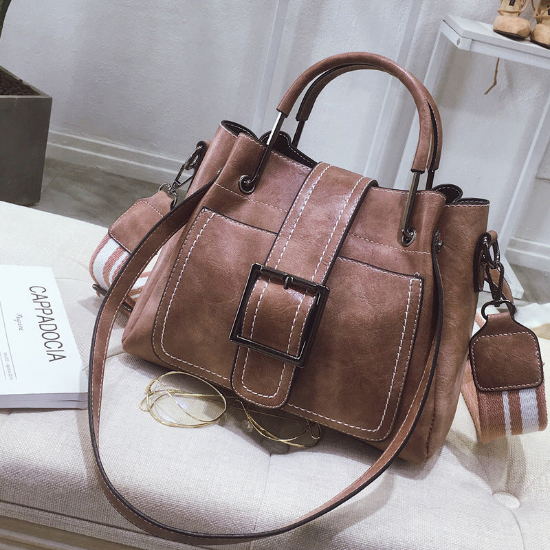 Elegant women's handbag by LadyShow.Store with a sleek design and neutral color, featuring a top handle and shoulder strap.