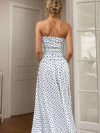 Polka dot strapless maxi dress by Shopimist featuring a flowing silhouette and bold black and white polka dot pattern.