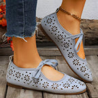 Floral cutout tied slip-on sandals by Plush Fashion Hub featuring open toes and decorative flower accents.