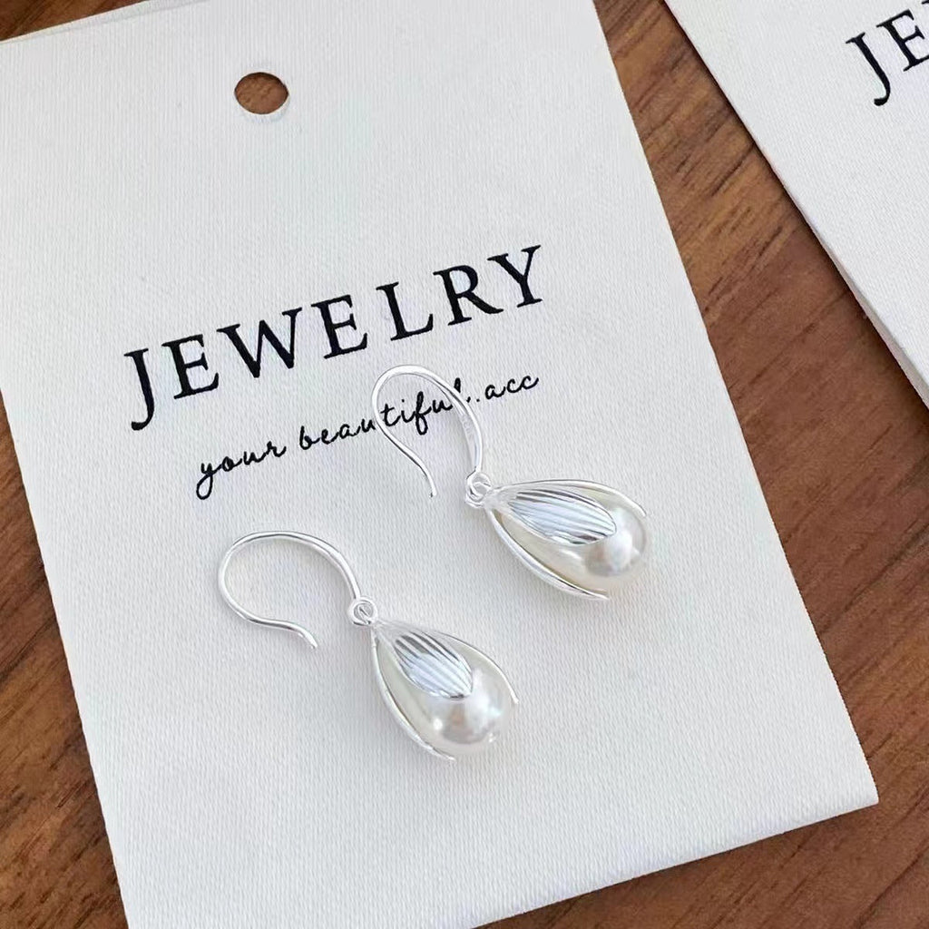 Sterling silver drop earrings with a sleek, elegant design, featuring polished 925 silver hooks and teardrop-shaped pendants.