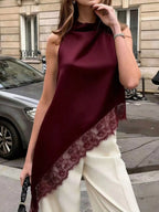 Polka dot lace trim sleeveless blouse with asymmetrical hem from Trendsi, featuring a stylish, lightweight shirt with feminine detailing.