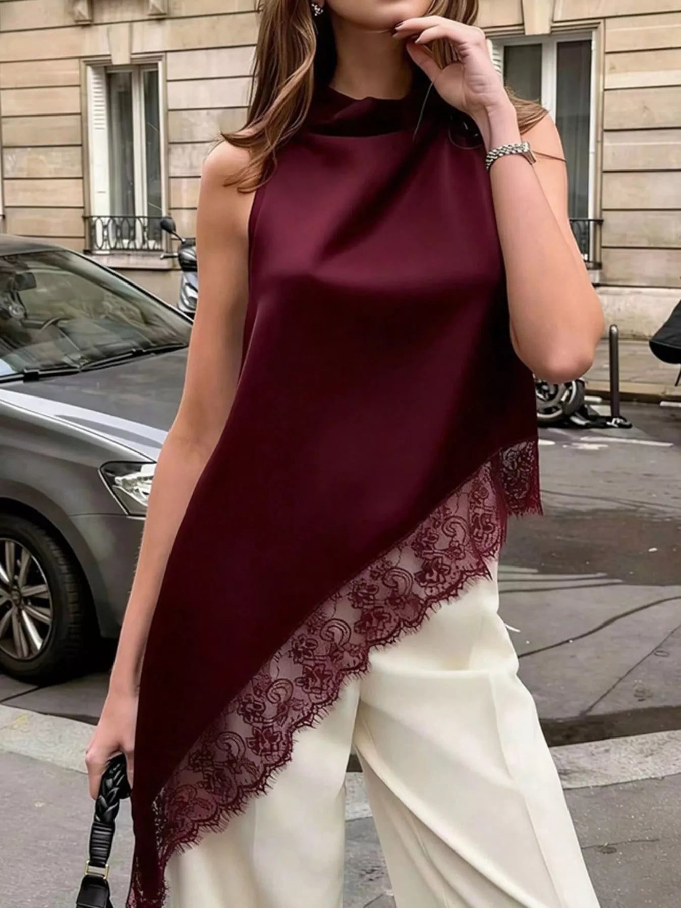 Polka dot lace trim sleeveless blouse with asymmetrical hem from Trendsi, featuring a stylish, lightweight shirt with feminine detailing.