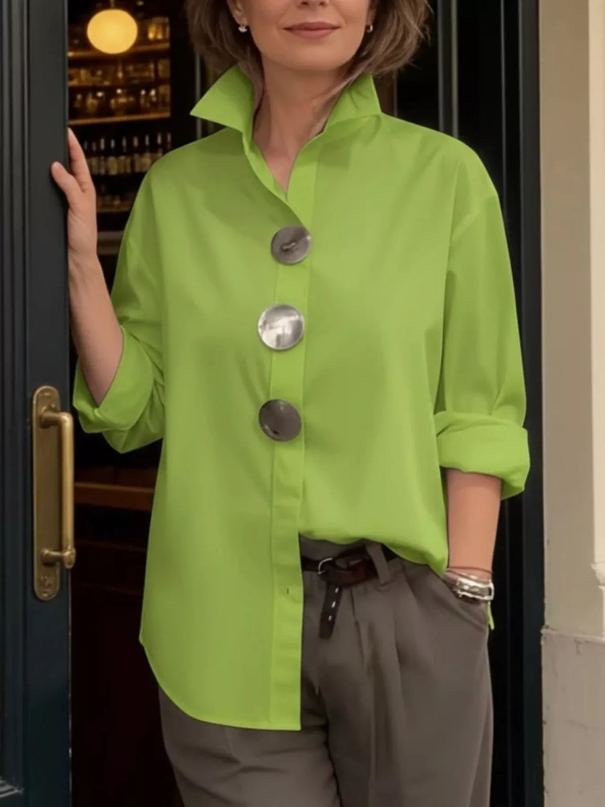 Plus size long sleeve shirt featuring oversized metal buttons from Trendsi, made of comfortable fabric with a relaxed fit.