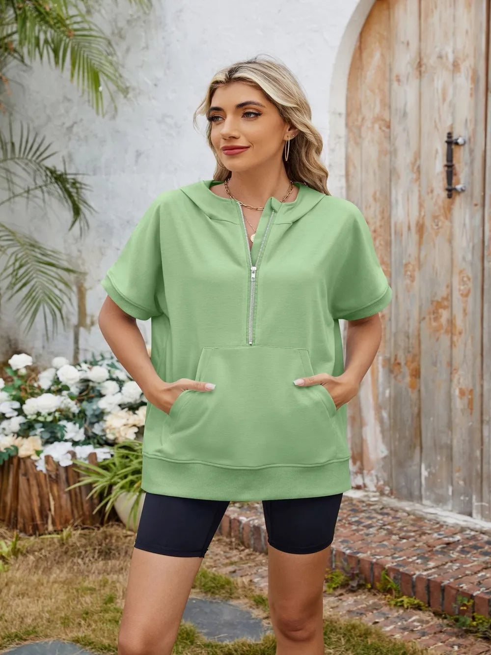 Gray half zip short sleeve hooded top from Trendsi featuring a front zipper and casual fit, ideal for layering and active wear.