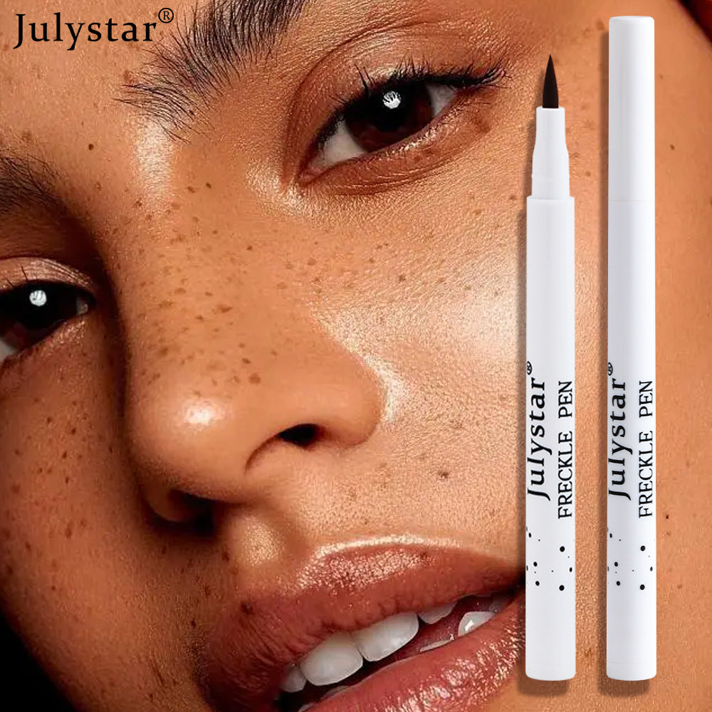 Two slim white plastic Julystar Freckle Pens against a face with freckles.