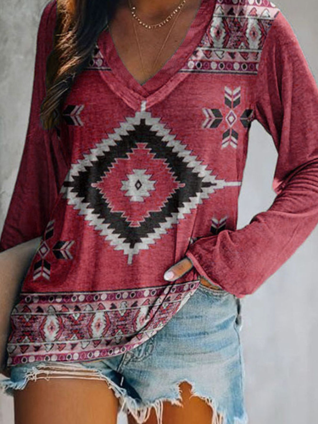 Plus size geometric print V-neck long sleeve T-shirt by Trendsi, comfortable casual top with modern pattern and relaxed fit.