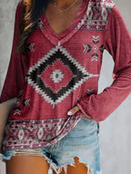 Plus size geometric print V-neck long sleeve T-shirt by Trendsi, comfortable casual top with modern pattern and relaxed fit.