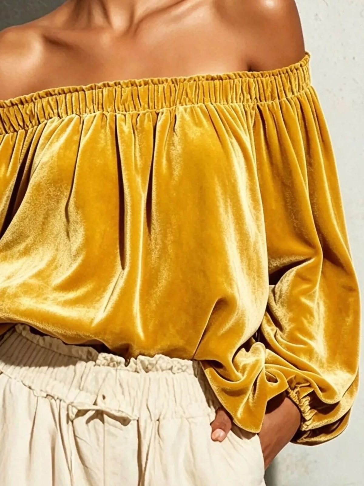 Black off-shoulder velvet long sleeve T-shirt by Trendsi featuring a fitted design and soft fabric for stylish comfort.