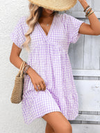 Plush Fashion Hub plaid V-neck mini dress with ruffle hem, lightweight fabric, perfect for seasonal casual wear.