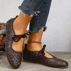 Floral cutout tied slip-on sandals from Plush Fashion Hub featuring a stylish open-toe design and floral accents.