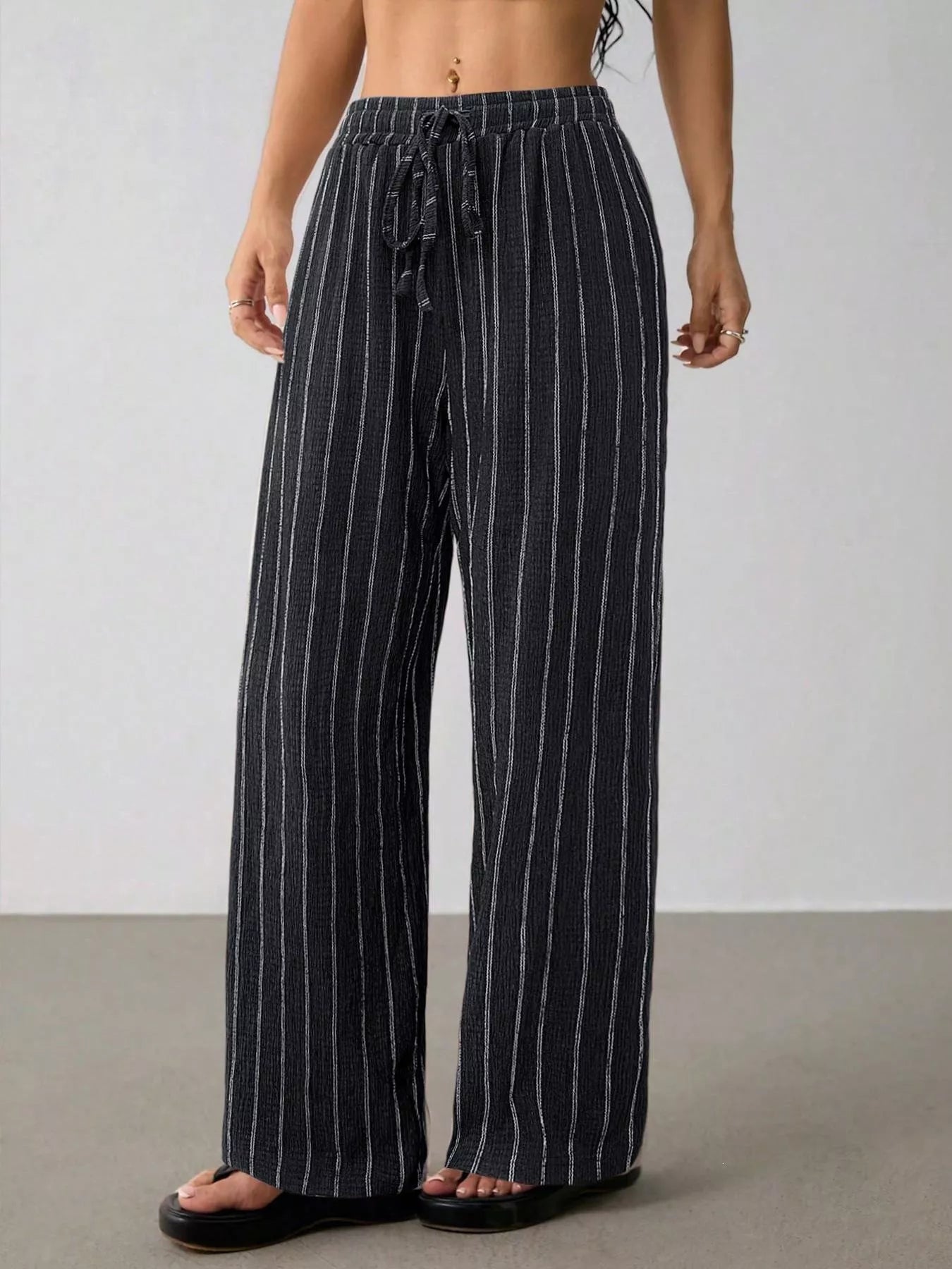 Striped wide-leg drawstring pants from Trendsi featuring a relaxed fit and comfortable waistband, stylish for casual wear.