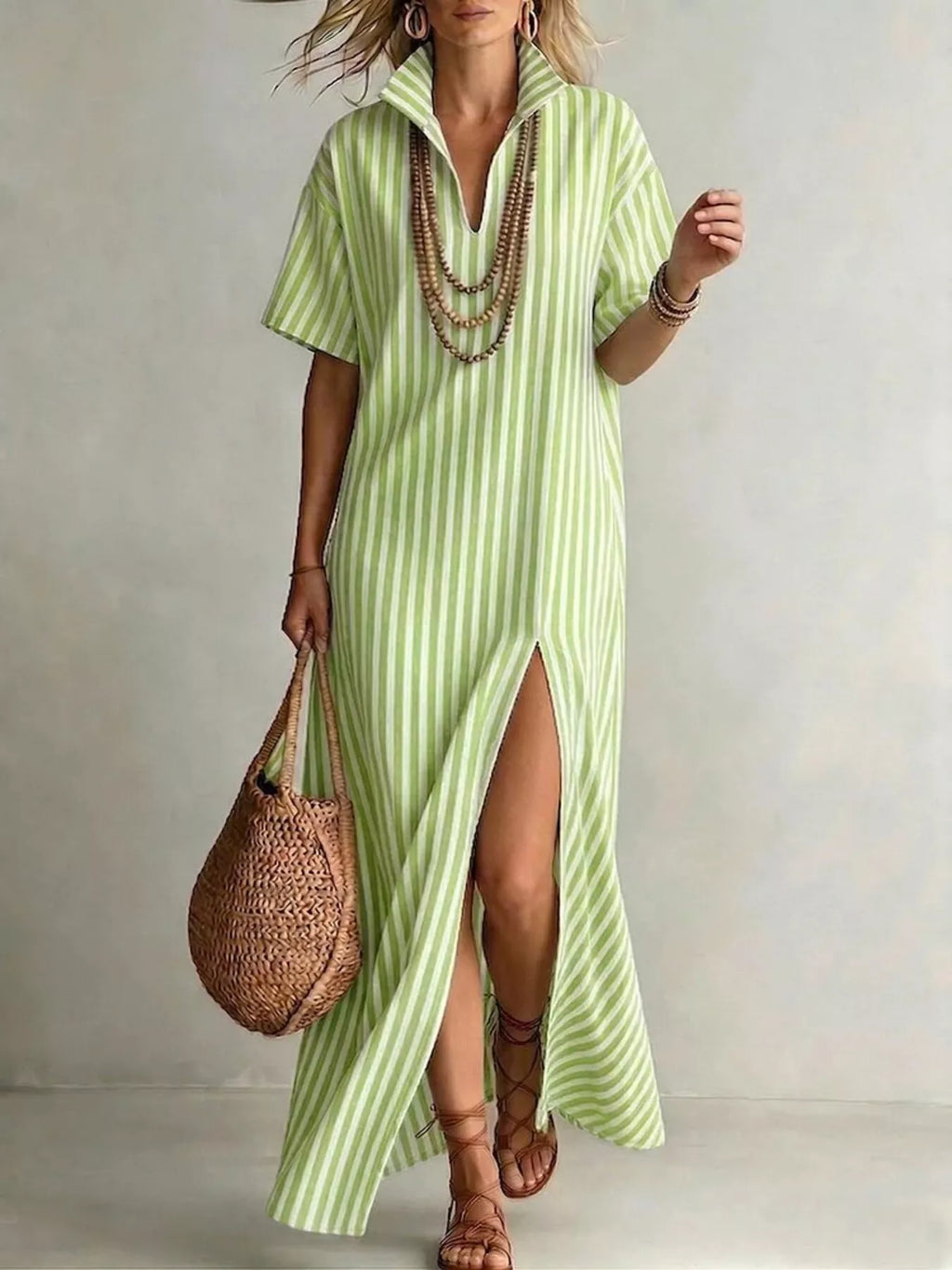 Striped high slit maxi shirt dress by Trendsi featuring a flowing design and a bold slit, perfect for casual or semi-formal wear.