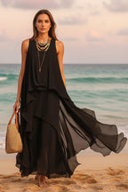Flowy black asymmetrical chiffon maxi dress by FitiqueFit featuring sleeveless, boho A-line design for women.