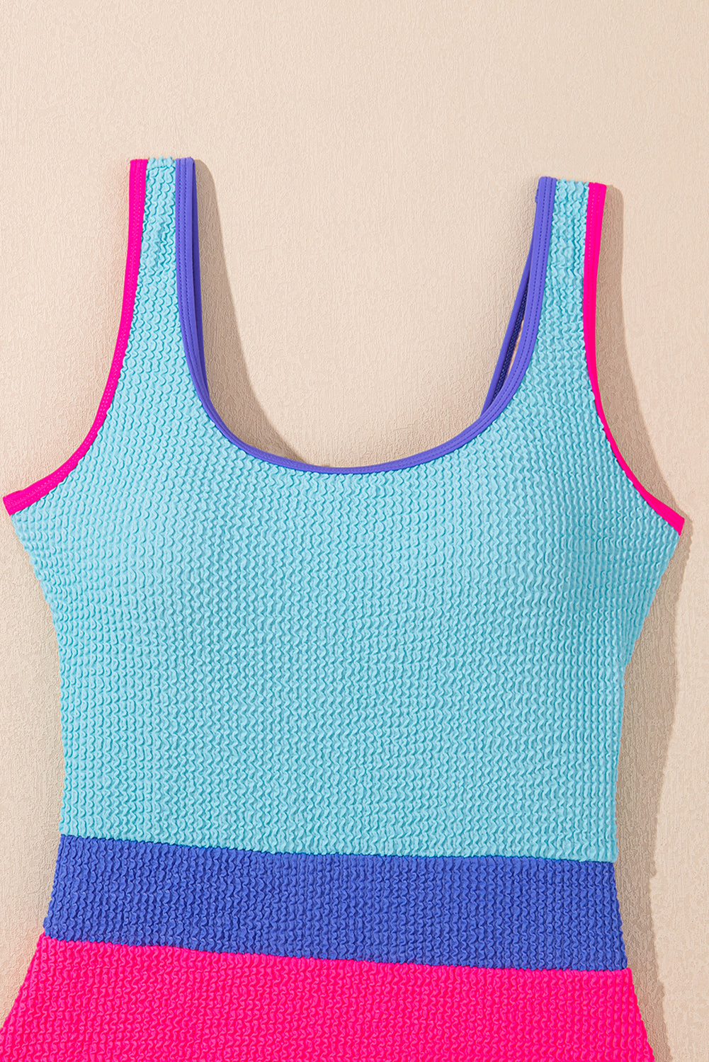 Colorful Rory patchwork one-piece swimsuit by Threaded Pear displayed on a model, featuring vibrant mixed fabric patterns.