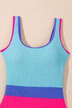 Colorful Rory patchwork one-piece swimsuit by Threaded Pear displayed on a model, featuring vibrant mixed fabric patterns.