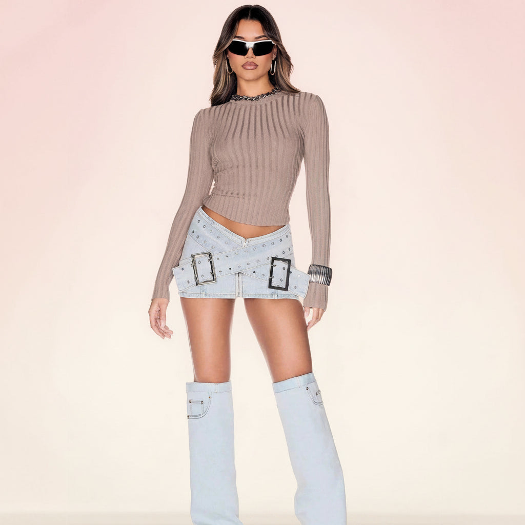 Women's light blue denim mini skirt with bodycon fit and cross-over buckle design by FitiqueFit, shown on a model.
