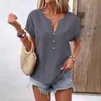 Light pink women's short-sleeve V-neck T-shirt top with button detail from Plush Fashion Hub, shown on a white background.