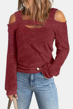 Women's elegant cold shoulder blouse by Trendsi, featuring cutout shoulders and a chic casual polyester top design.